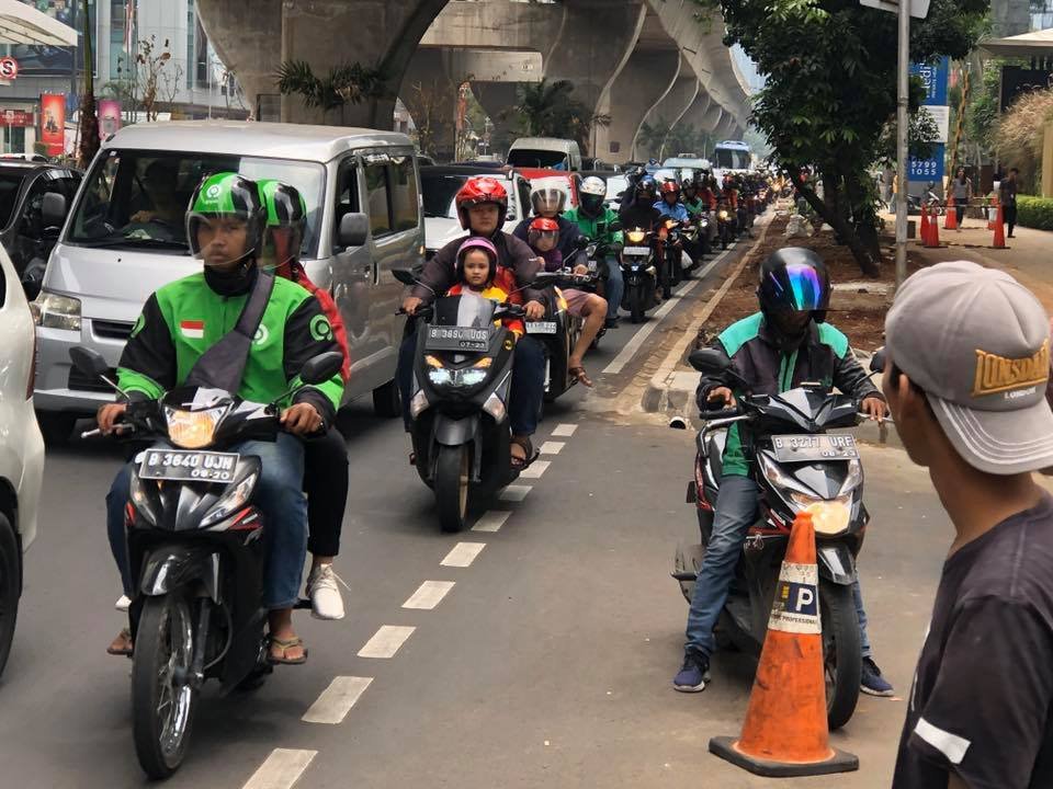What business are companies like GRAB and GOJEK in?