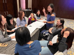 A group of female discussing their key results from different departments and what needs to be measured.