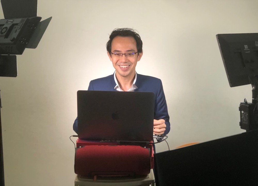 Kenneth Kwan delivering a keynote from his virtual studio setup